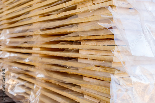 Layers of thin wooden planks covered in transparent plastic.