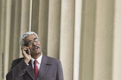 Senior businessman talking on mobile phone