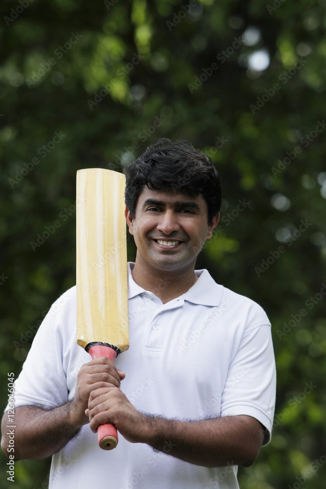 Indian man holding cricket bat