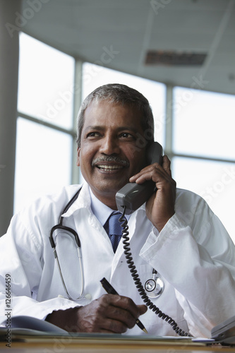 Indian doctor talking on phone and smiling