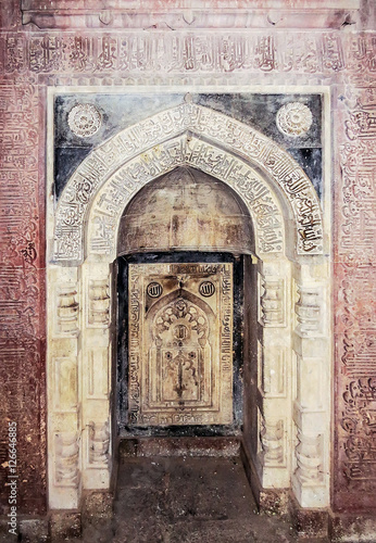 Decorated in Arabic script niche of ancient tomb Isa Khan's the 16th century, near architectural complex Humayun Tomb in New Delhi, India