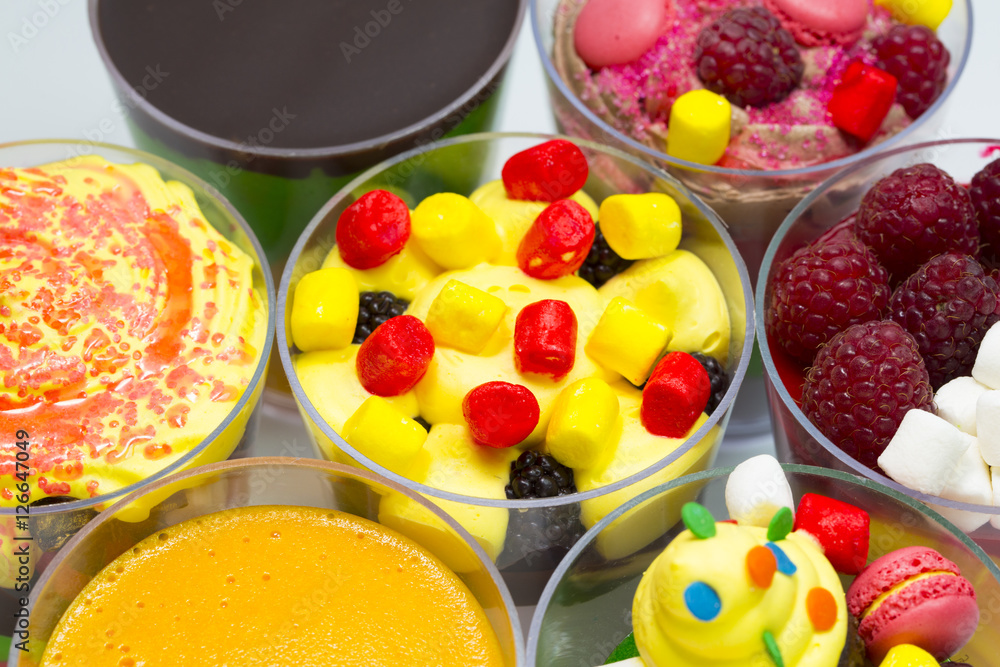 Dessert in plastic cups cream with fruit and pastries and mousse Dessert in plastic cups cream with fruit and pastries and mousse