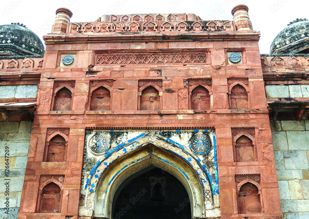 The facade of the main entrance to the ancient mosque of Isa Khan, the 16th century, in a park next to the architectural complex Humayun Tomb in New Delhi, India