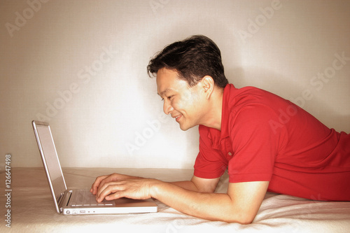 Man using laptop, profile