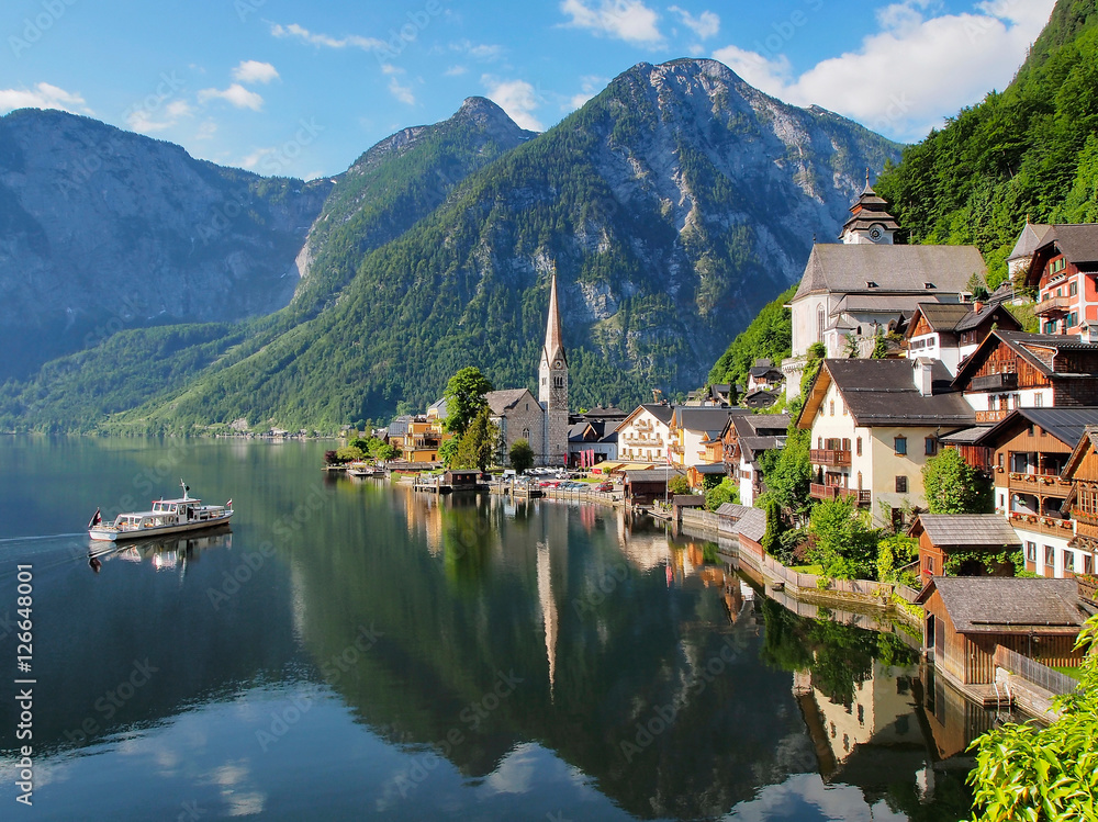 Famous view on the lake and city Hallstatt. Beautiful morning light, most visited alpine lake