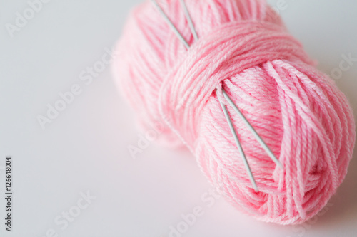 knitting needles and ball of pink yarn