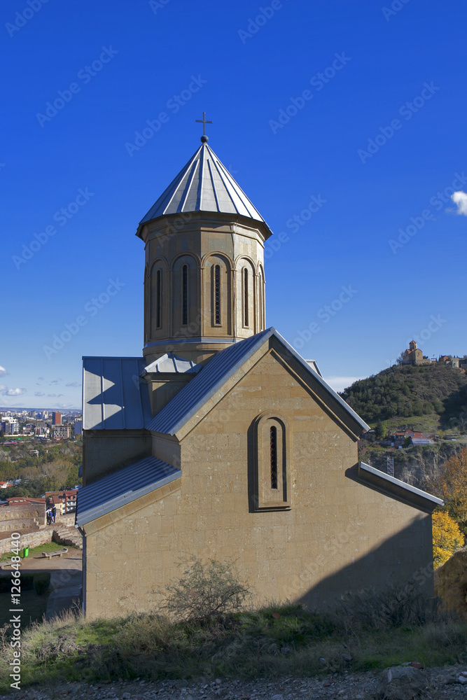 Narikala Fortress with the St Nikolas church and the architecture in the surrounding Old Town of Tbilisi, Republic of Georgia, Caucasus, in the early morning, at sunrise.