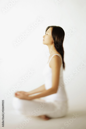 Young woman sitting on floor, profile