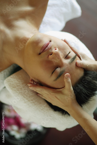 Young man receiving head massage