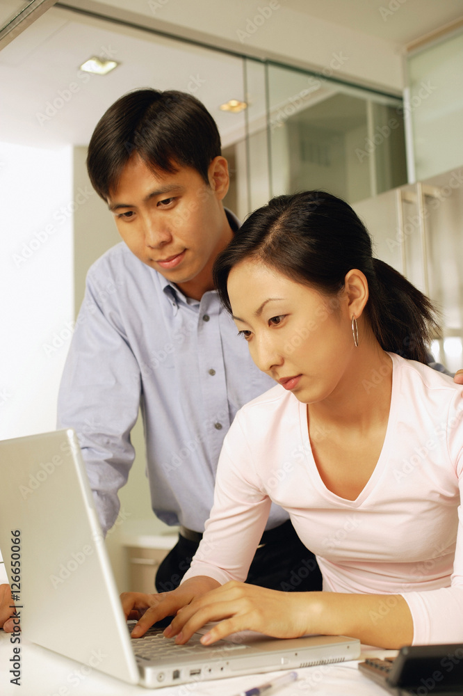Young couple using laptop at home Young couple using laptop at home