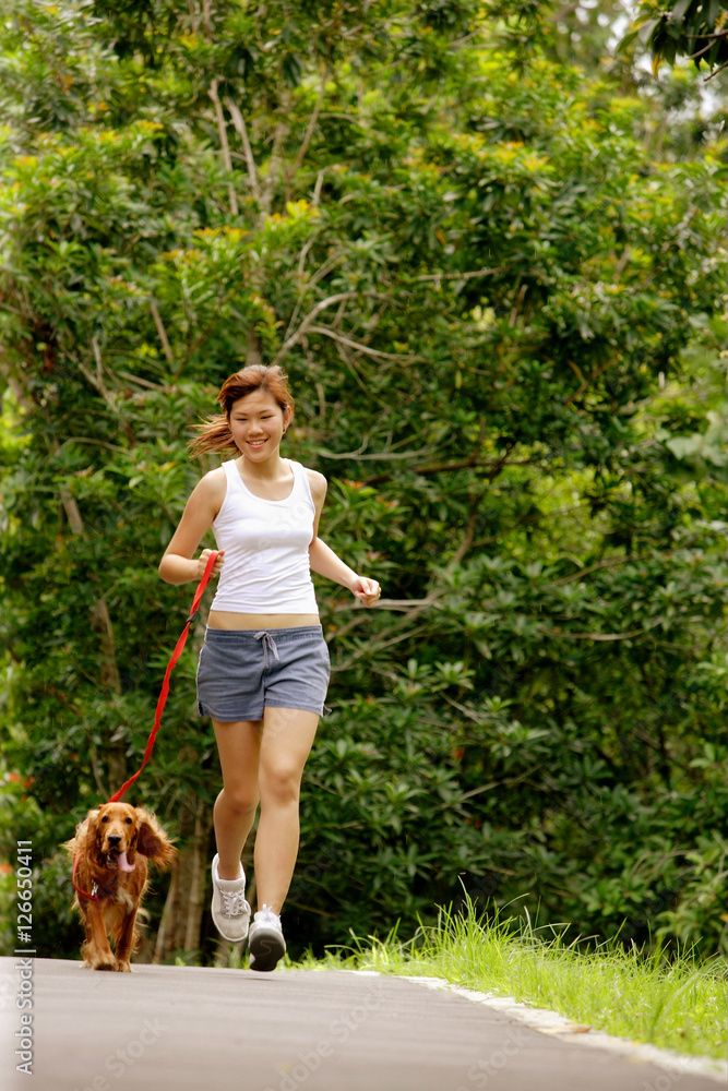Young woman jogging with her dog Young woman jogging with her dog