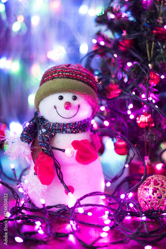 Christmas composition with smiling snowman. Christmas funny decorative snowmen on wooden board on lights background Christmas with copy space