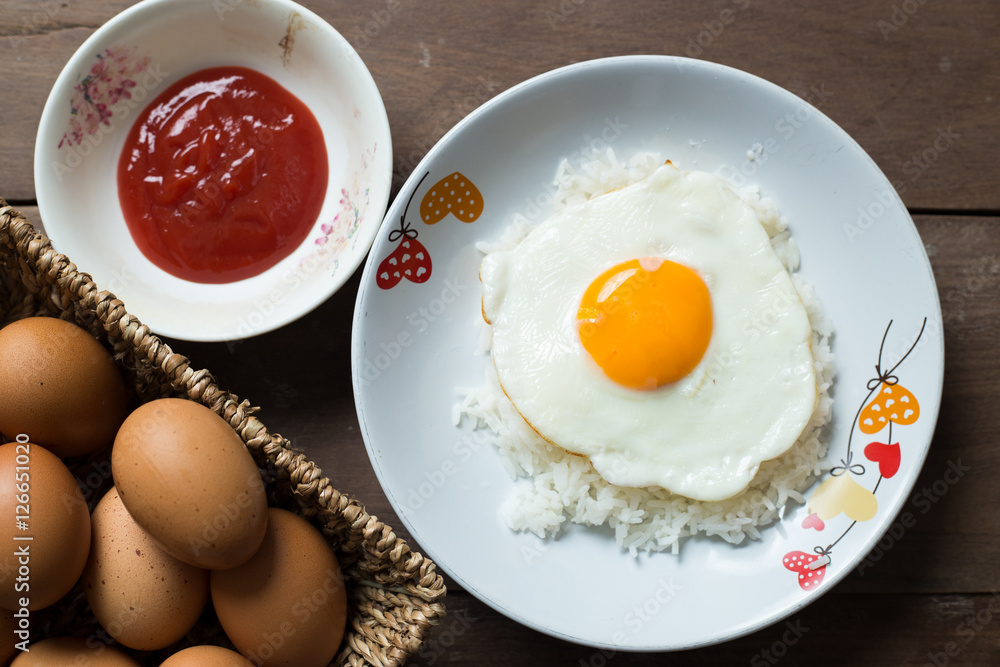 Fried egg on cooked rice and fresh eggs. Fried egg on cooked rice and fresh eggs.