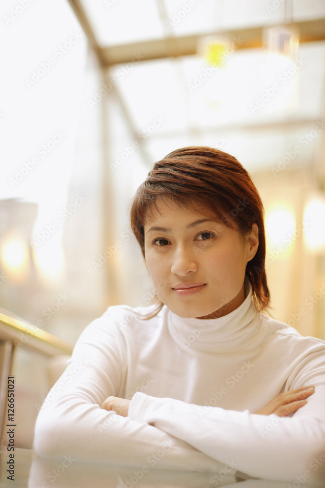 Young woman wearing white turtleneck looking at camera Young woman wearing white turtleneck looking at camera