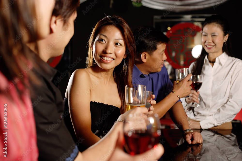 Fototapeta premium Men and women at bar, drinking