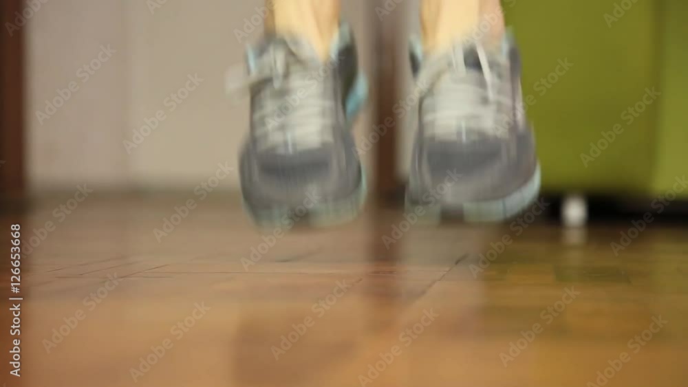 Close-up shot of woman jumping on a skipping rope in a gym. Sports concept Close-up shot of woman jumping on a skipping rope in a gym. Sports concept