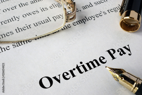 Overtime pay concept written on a paper.