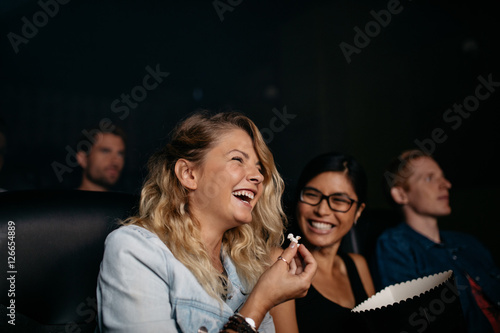 Fotografia Girls laughing and watching comedy movie.