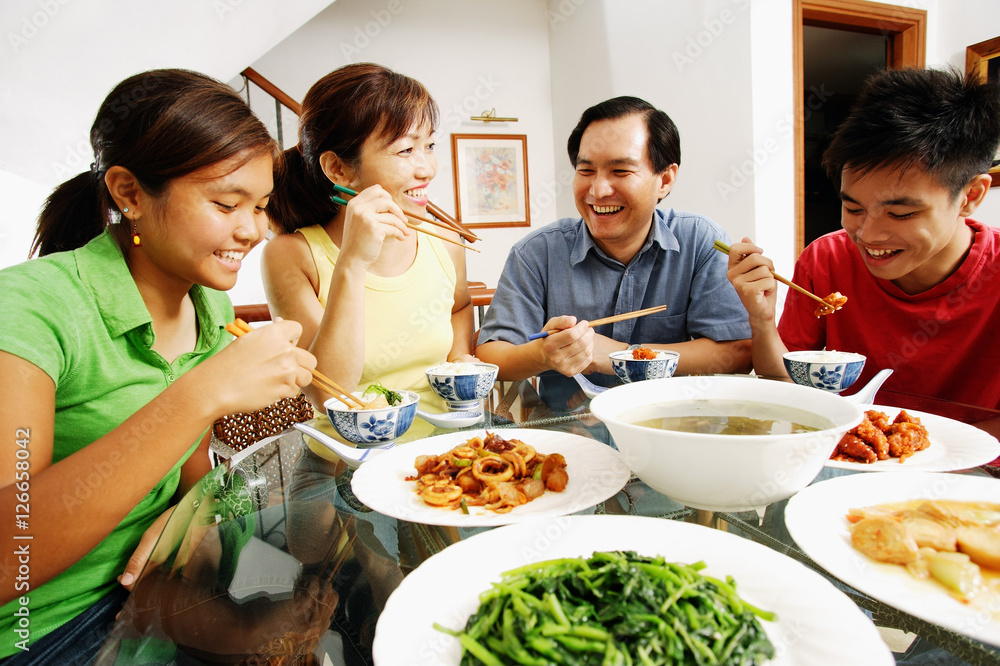 Family eating dinner at home Family eating dinner at home