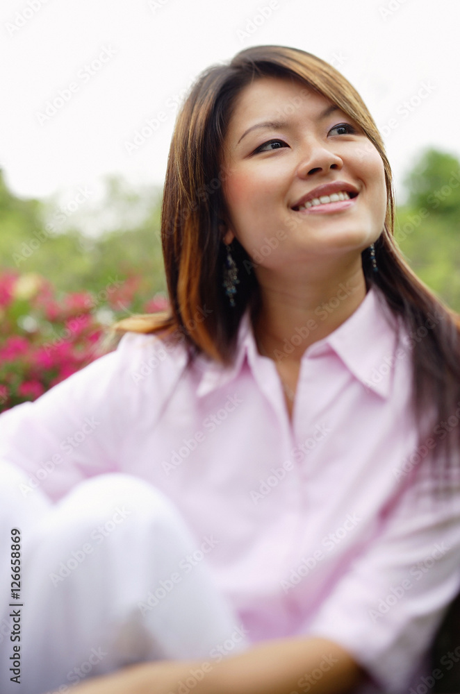 Woman looking at away, hugging knee, portrait Woman looking at away, hugging knee, portrait