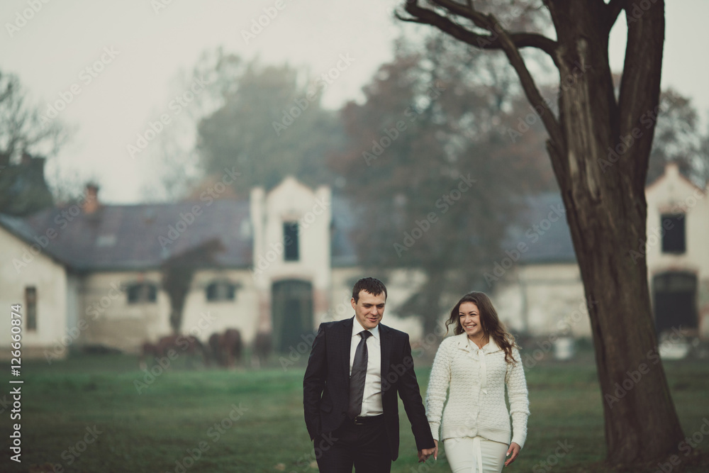 Happy wedding couple is walking down Happy wedding couple is walking down