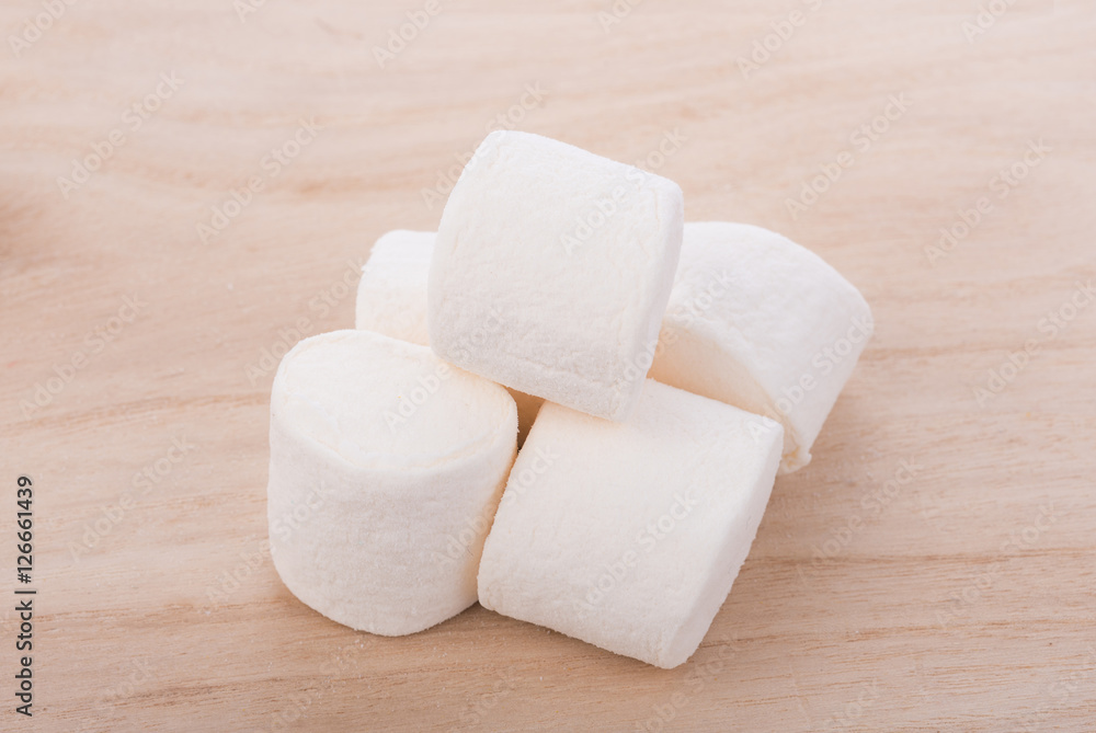 white marshmallows on wooden background white marshmallows on wooden background