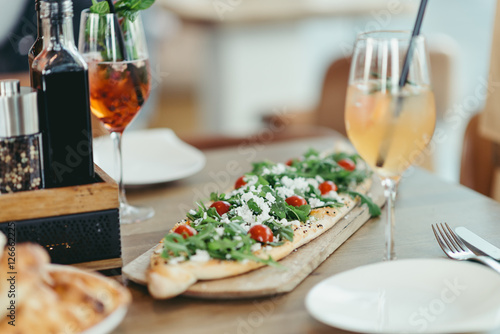 turkish pide with feta cheese, rucola and tomato in restaurant