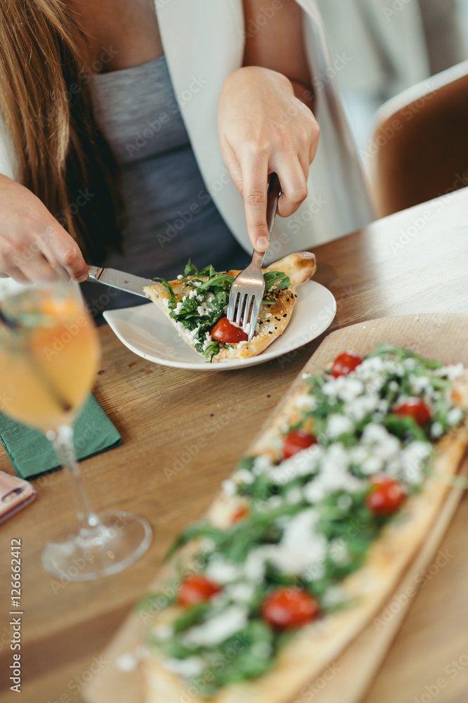 Hands of unknown Person take a piece of turkish pide with feta cheese Hands of unknown Person take a piece of turkish pide with feta cheese