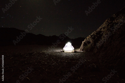 Night shot of tent lit from inside 
