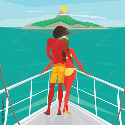 Young couple in love standing on the front of the boat deck and looks at an island in the distance. View from the back - Cruise or sea voyage concept