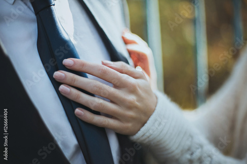 Tender bride's hands on her groom