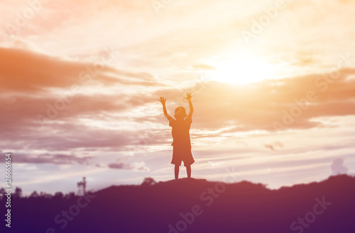 silhouette of a happy children and happy time sunset