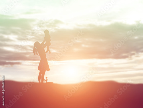a silhouette of a happy young girl child the arms of his loving