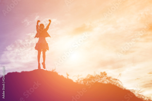 Fototapeta Naklejka Na Ścianę i Meble -  Happy woman jumping against beautiful sunset. Freedom, enjoyment