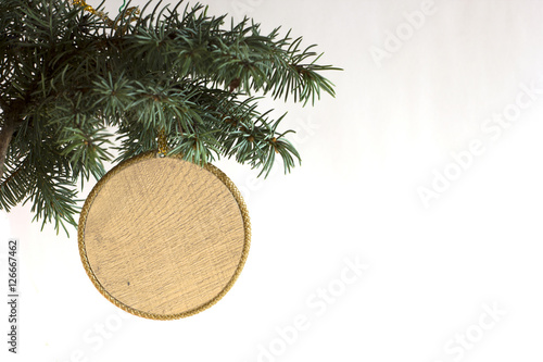 Happy New Year and merry Christmas template copyspace card with hand made craft circle wooden label decorated on Christmas tree branch. White concept price and description winter sale item background.