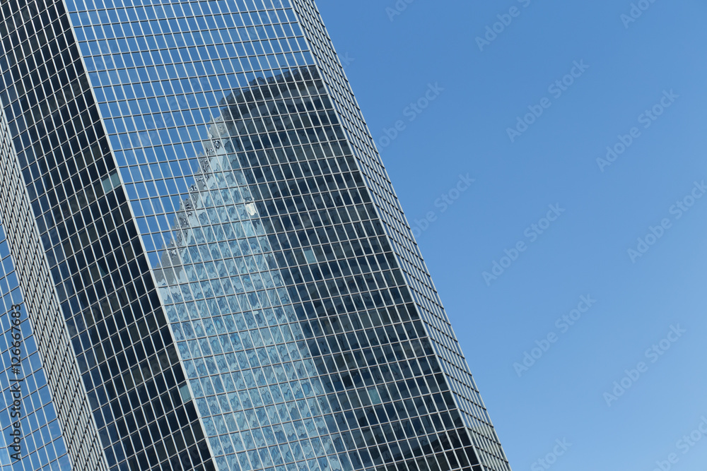 Skyscrapers with glass facade. Modern buildings in Paris business district. Concepts of economics, financial, future.  Copy space for text. Dynamic composition. Toned