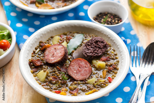 Lentil stew with carrots, potato, bell pepper and sausages