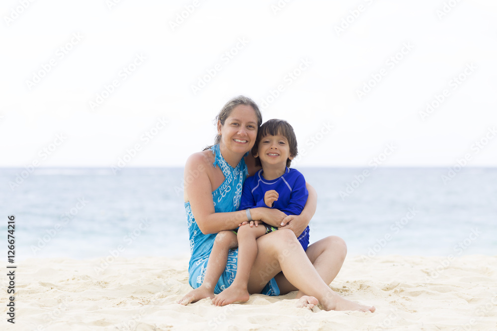 Lovely Mother and Boy Sitting on the Beach Lovely Mother and Boy Sitting on the Beach