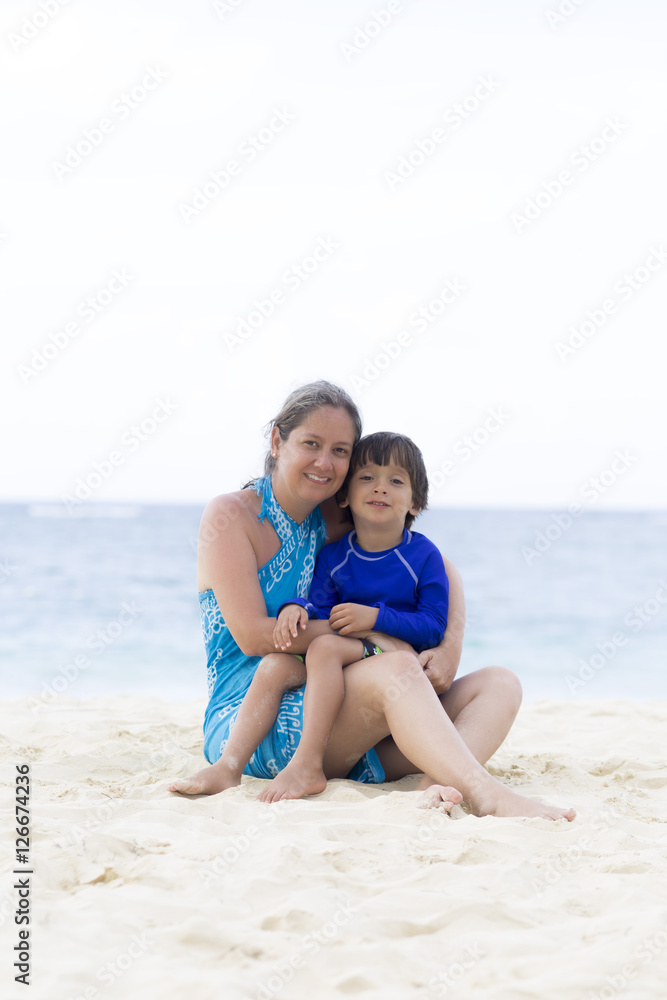 Lovely Mother and Boy Sitting on the Beach Lovely Mother and Boy Sitting on the Beach