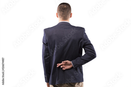 Man in a suit crossed his fingers behind his back