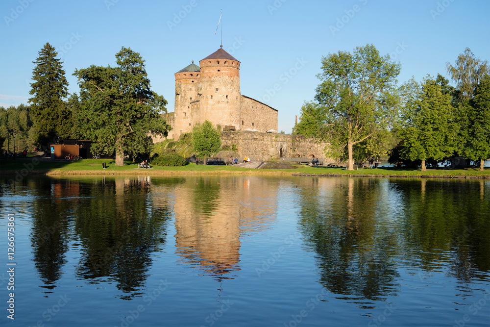 View of Olavinlinn's fortress on the Saimaa lake in the August evening. Savonlinna, Finland