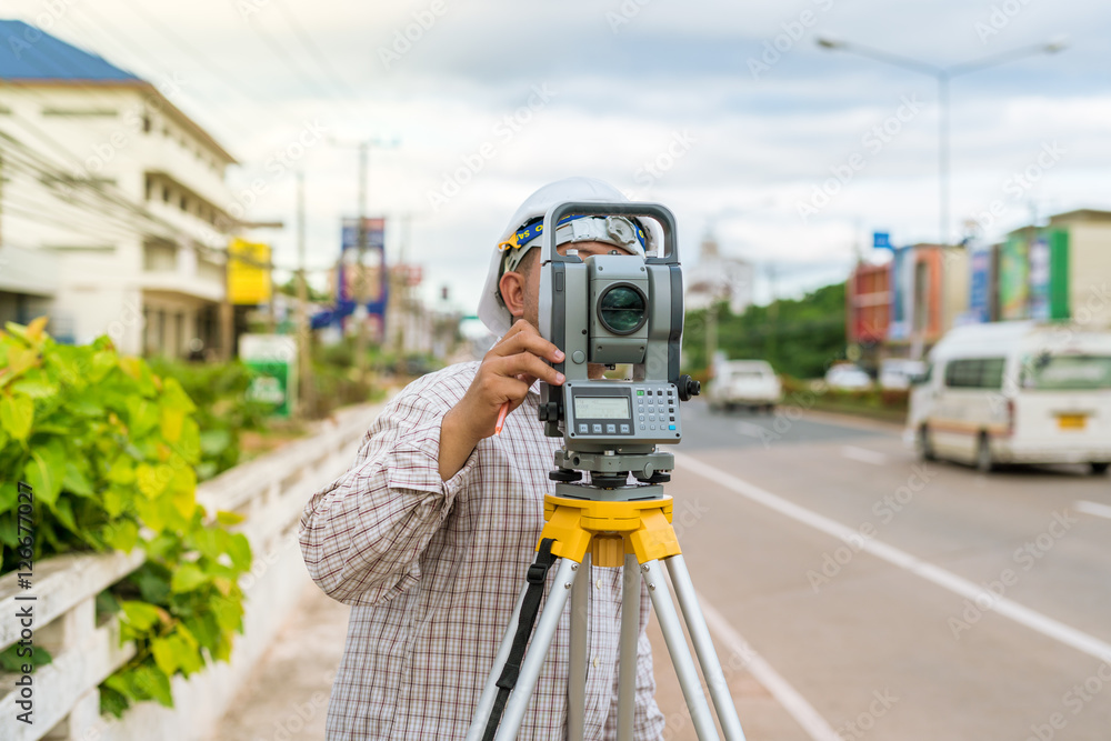 A surveyor at work with an infrared reflector used for distance measurement on roadside
A land surveying professional is called a land surveyor. A surveyor at work with an infrared reflector used for distance measurement on roadside
A land surveying professional is called a land surveyor.