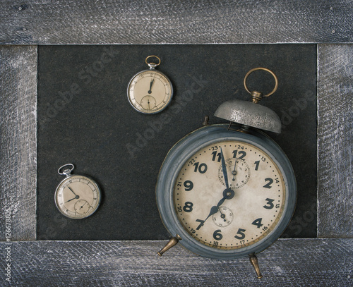 Old pocket watch and alarm clock