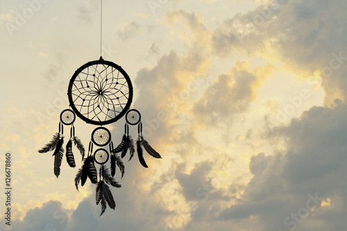Indian dreamcatcher silhouette at sunset