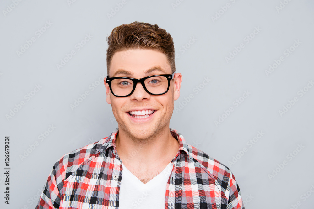 Portrait of handsome young man in glasses with beaming smile