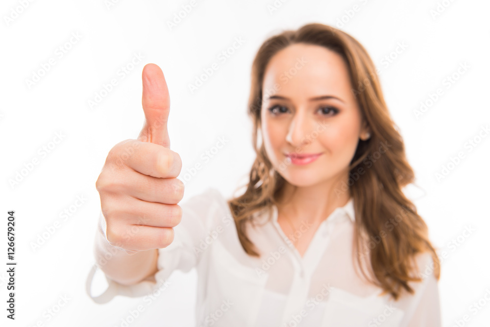 Attractive woman showing thumb up, focus on hand Attractive woman showing thumb up, focus on hand