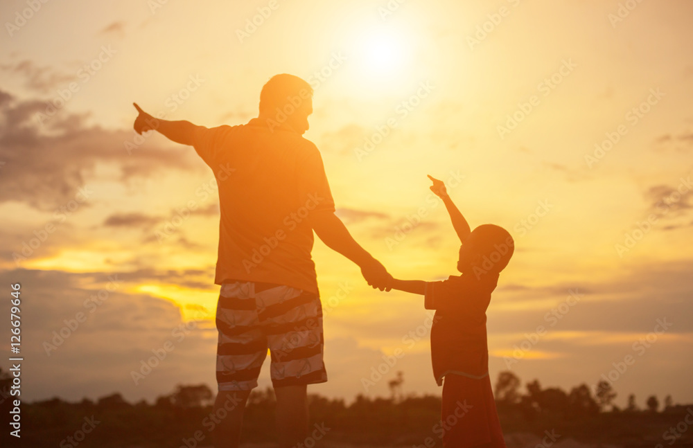 Happy dad throws the baby at sunset