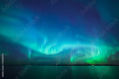 Obraz na plátně Northern lights over lake in finland
