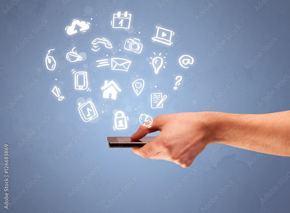 Hand holding tablet phone with drawn icons Hand holding tablet phone with drawn icons