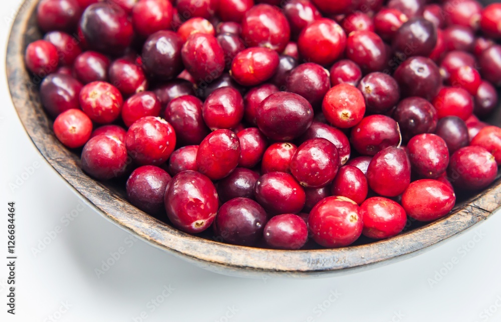 Fresh cranberries in wooden bowl Fresh cranberries in wooden bowl